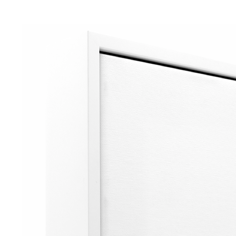 Floating frame canvas print corner with white frame and textured canvas close-up